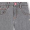 Pantalone in denim con borchie a stella laterali