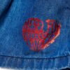 Short in denim con logo stampato laminato